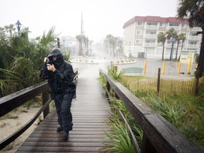 Bethany Kellam walks onto the southend beach of Tybee Island, Ga., Monday, Sept., 11, 2017. The National Weather Service placed most of Georgia under a tropical storm warning. (AP Photo/Stephen B. Morton)