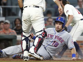 New York Mets' Travis d'Artaud (18) scores on a hit by teammate Gavin Cecchini in the second inning of a baseball game against the Atlanta Braves in Atlanta, Saturday, Sept. 16, 2017. (AP Photo/Tami Chappell)