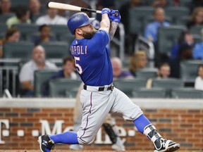 Texas Rangers pinch-hitter Mike Napoli hits a single during the ninth inning of the second game of a baseball doubleheader against the Atlanta Braves, Wednesday, Sept. 6, 2017, in Atlanta. The Braves won 5-4. (AP Photo/Todd Kirkland)