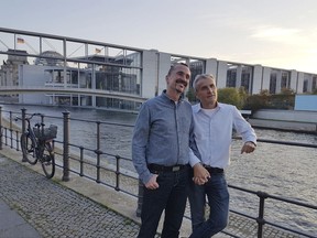 In this Friday Sept. 29, 2017 photo Karl Kreile, left, and Bodo Mende, pose for journalists  in Berlin, Germany. Almost forty years after their first kiss, Karl and Bodo are getting hitched. The two civil servants are expected to become the first gay couple to tie the knot in Germany when a law allowing same-sex marriages comes into effect Sunday Oct. 1, 2017.  (AP Photo/Frank Jordans)