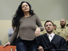 In this June 20, 2017 photo, Beate Zschaepe arrives in court in Munich besides her lawyer Mathias Grasel.