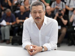 Hong Sang-soo poses on May 21, 2017 during a photocall for the film 'Claire's Camera (Keul-Le-eE-Ui-Ka-Me-La)' at the 70th edition of the Cannes Film Festival in Cannes, southern France.