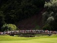 Spectators cross the bridge between the 13th and 14th holes during the Canadian Open golf tournament at Glen Abbey golf club, in Oakville, Ont., on Saturday, July 29, 2017.