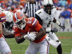 Florida running back Lamical Perine (22) runs for a 1-yard touchdown past Vanderbilt cornerback Joejuan Williams (8) during the first half of an NCAA college football game, Saturday, Sept. 30, 2017, in Gainesville, Fla. (AP Photo/John Raoux)