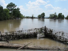 At the Highlands Acid Pit on Thursday, Aug. 31, 2017, the No Trespassing sign on the barbed-wire fence encircling the 3.3-acre Superfund site barely peeked above the churning flood water from the nearby San Jacinto River.