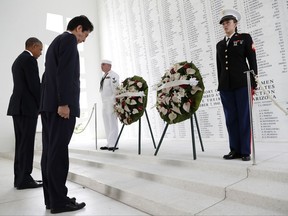 FILE - In this Dec. 27, 2016 file photo, President Barack Obama and Japanese Prime Minister Shinzo Abe participate in a wreath laying ceremony at the USS Arizona Memorial at Joint Base Pearl Harbor-Hickam as part of a ceremony to honor those killed in the Japanese attack on the naval harbor. Dozens of descendants of Japanese soldiers killed in World War II arrived in Honolulu on Thursday, Sept. 21, 2017 to pay respects to American war dead. Nippon Izokukai, the Bereaved Family Association of Japan, sent 36 children, grandchildren and other relatives of fallen Japanese soldiers to the U.S. to mark the 70th anniversary of the group's founding. The group will lay flowers at the USS Arizona before they travel to Washington for visits to Arlington National Cemetery and the Iwo Jima Memorial. (AP Photo/Carolyn Kaster, File)