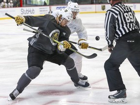 Vegas Golden Knights' William Karlsson, left, and Vadim Shipachyov face off with a linesman during practice last week. The opening of the NHL pre-season saw centres repeatedly thrown out of faceoff circles and a parade of players to the penalty box with slashing calls.