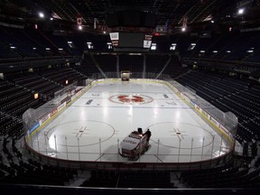 In this Jan. 7, 2013 file photo, the ice is cleaned at the Saddledome in Calgary.