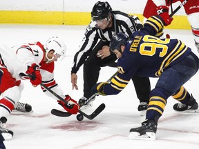 Carolina's Lucas Wallmark, left, and Buffalo's Ryan O'Reilly take a faceoff during a preseason NHL hockey game on Monday Sept. 18, 2017, in Buffalo, N.Y.