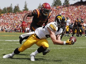 Iowa wide receiver Matt VandeBerg catches a 17-yard touchdown pass in front of Iowa State defensive back Brian Peavy, left, during the first half of an NCAA college football game, Saturday, Sept. 9, 2017, in Ames, Iowa. (AP Photo/Charlie Neibergall)