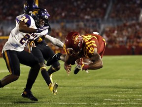 Iowa State running back David Montgomery (32) dives into the end zone ahead of Northern Iowa defensive back Nikholi Jaghai (24) during an 8-yard touchdown run in the first half of an NCAA college football game, Saturday, Sept. 2, 2017, in Ames, Iowa. (AP Photo/Charlie Neibergall)