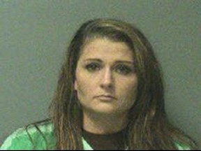 This photo provided by City of Johnston, Iowa shows Erin Macke.    Police have arrested Macke, a suburban Des Moines mother who left her four children home alone while she traveled to Europe.  Johnston police have charged Macke, 30, with four counts of child endangerment and one of transferring a firearm to a person under 21. Police said the latter charge was filed because a firearm was within reach of the children in the home.  (City of Johnston, Iowa via AP)