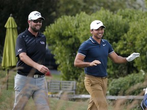 Marc Leishman, left, and Jason Day laugh as they walk to the fourth fairway during the third round of the BMW Championship golf tournament at Conway Farms Golf Club, Saturday, Sept. 16, 2017, in Lake Forest, Ill. (AP Photo/Charles Rex Arbogast)
