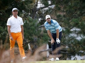 Marc Leishman, right, looks at his tee shot on the fourth hole as Rickie Fowler heads to the fairway during the final round of the BMW Championship golf tournament at Conway Farms Golf Club, Sunday, Sept. 17, 2017, in Lake Forest, Ill. (AP Photo/Charles Rex Arbogast)