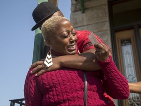 In this Sunday, Sept. 10, 2017, photo, Teresa Jenkins is comforted by her boyfriend on the porch of her apartment as she talks about her daughter, Kenneka Jenkins in Chicago. Police investigating Jenkins' death, whose body was found inside a suburban Chicago hotel freezer, are examining a video that appears to show her in a room at the hotel hours earlier. (Alyssa Pointer/Chicago Tribune via AP)