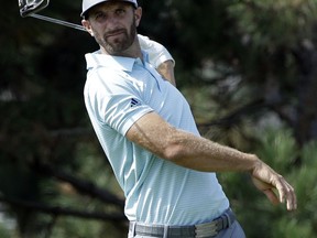 Dustin Johnson watches his tee shot on the fourth hole during the first round of the BMW Championship golf tournament at Conway Farms Golf Club, Thursday, Sept. 14, 2017, in Lake Forest, Ill. (AP Photo/Nam Y. Huh)