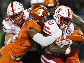 Nebraska running back Mikale Wilbon (21) runs the ball under pressure from Illinois linebacker Julian Jones (2) during the first half of an NCAA college football game Friday, Sept. 29, 2017, in Champaign, Ill. (AP Photo/Stephen Haas)