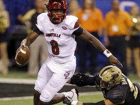 Louisville quarterback Lamar Jackson (8) gets away from Purdue linebacker Markus Bailey (21) during the first half of an NCAA college football game in Indianapolis, Saturday, Sept. 2, 2017. (AP Photo/Michael Conroy)