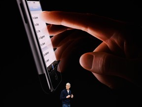 CEO Tim Cook talks about Apple's new iPhones at the company's California headquarters.
