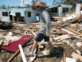 A man surveys the damage caused to his trailer home from Hurricane Irma at the Seabreeze Trailer Park in Islamorada, in the Florida Keys, Sept. 12, 2017.