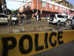 Pakistani security personnel cordon off the area of an attack in Karachi, Pakistan, Saturday, Sept 2, 2017. Pakistani police said two gunmen targeting an ethnic party lawmaker after Eid prayers instead gunned down two others, including a child, in the southern port city of Karachi. (AP Photo/Fareed Khan)