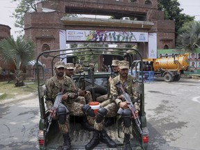 Pakistan army soldiers patrol near Gaddafi Stadium to ensure security ahead of the start of first Twenty20 cricket match between the World XI team and Pakistan, in Lahore, Pakistan, Tuesday, Sept. 12, 2017. The World XI team led by South Africa's Faf du Plessis arrived in Lahore amid tight security to play a three-match Twenty20 series against Pakistan. (AP Photo/K.M. Chaudary)