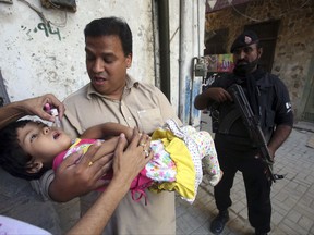 A health worker gives a polio vaccine to a child in Peshawar, Pakistan, Monday, Sept. 18, 2017, Polio remains endemic in Pakistan after the Taliban banned vaccinations, instigated attacks targeting medical staffers and spread suspicions about the vaccine. (Muhammad Sajjad)