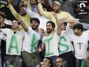 Pakistani cricket fans watch a match between World XI and Pakistan at Gaddafi stadium, in Lahore, Pakistan, Tuesday, Sept. 12, 2017. Spectators in the heavily guarded stadium showed their appreciation for the World XI, the first major cricket team to visit Pakistan in eight years. (AP Photo/K.M. Chaudary)