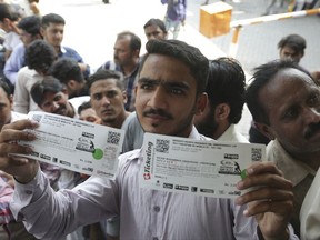 A Pakistani cricket fan shows tickets bought for the upcoming World XI series at Gaddafi stadium in Lahore, Pakistan, Thursday, Sept. 7, 2017. The series is aimed at reviving international cricket in Pakistan, since terrorists attacked the Sri Lanka cricket team bus in Lahore in 2009. (AP Photo/K.M. Chaudary)