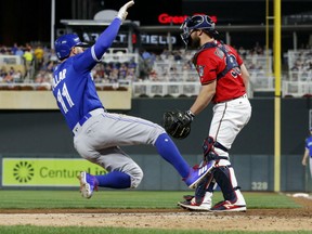 Toronto Blue Jays' Kevin Pillar scores what proves to be the game-winning run against the Minnesota Twins during MLB action Firday night in Minnesota. The Jays were 4-3 winners. Catcher  is Chris Gimenez.