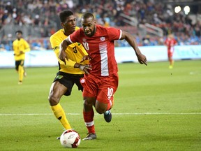 Team Canada's David Junior Hoilett (right) moves around Team Jamaica's Damion Lowe during the second half of their international friendly soccer game Saturday September 2, 2017 in Toronto. THE CANADIAN PRESS/Jon Blacker