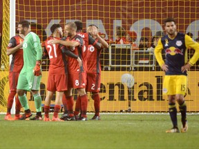 Toronto FC teammates celebrate following their 4-2 victory over the New York Red Bulls in MLS soccer action Saturday September 30, 2017 in Toronto. THE CANADIAN PRESS/Jon Blacker