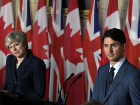 Prime Minister Justin Trudeau and British Prime Minister Theresa May listen to a question during a joint press conference on Parliament Hill in Ottawa on Monday, Sept. 18, 2017. THE CANADIAN PRESS/Justin Tang