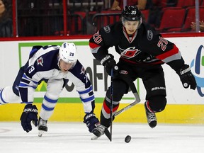 In this Nov. 20, 2016 file photo, Carolina Hurricanes forward Sebastian Aho (right) races for the puck against the Winnipeg Jets.