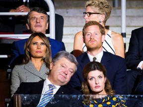Britain's Prince Harry, middle row right, takes in the opening ceremonies of the Invictus Games in Toronto on Saturday, Sept. 23, 2017. Front row from left, Petro Poroshenko, President of Ukraine, Maryna Poroshenko, first lady of Ukraine, middle row from left, Melania Trump, first lady of the United States, and Prince Harry, back row from left, Dr. Ralf Speth, CEO Jaguar Land Rover, and Kathleen Wynne, Premier of Ontario. (Nathan Denette/The Canadian Press via AP)