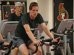 Thomas Chabot rides an exercise bike during Ottawa Senators development camp on June 28.