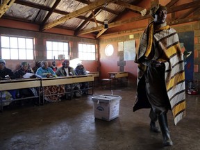 FILE-- In this Saturday, June 3, 2017 file photo, a man walks away after casting his vote at a polling station, in Ha Mampho village, Lesotho. The shooting death in early September of the country's military commander, Lt. Gen. Khoantle Motsomotso, by two rival officers who were killed in the gunfight heightened regional concerns about Lesotho, whose mostly peaceful elections in June gave hope that stability was being restored. (AP Photo/Themba Hadebe,File)