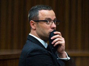 FILE - In this photograph taken on Tuesday, May 19, 2014, Oscar Pistorius listens to psychiatric evidence for his defense, during his ongoing murder trial in Pretoria, South Africa. Pistorius faces another legal challenge when South Africa's Supreme Court of Appeal convenes Nov. 3, 2017 to hear arguments by state prosecutors that the former track star and convicted murderer should get more jail time. (AP Photo/Daniel Born, Pool, File)