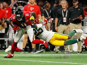 Julio Jones of the Atlanta Falcons fights off the tackle of Green Bay Packers' Kentrell Brice during NFL action Sunday night at Mercedes-Benz Stadium in Atlanta. Jones had five catches for 108 yards in Atlanta's 34-23 victory.