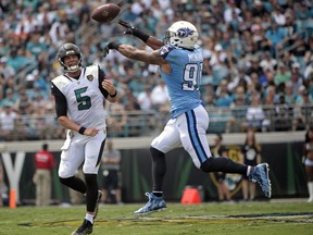 Tennessee Titans outside linebacker Derrick Morgan, right, knocks down a pass thrown by Jacksonville Jaguars quarterback Blake Bortles (5) during the first half of an NFL football game, Sunday, Sept. 17, 2017, in Jacksonville, Fla. (AP Photo/Phelan M. Ebenhack)