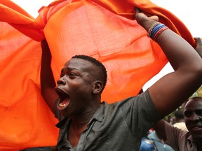 A supporter of opposition leader Raila Odinga celebrates after hearing the verdict in Kibera Slums in Nairobi.