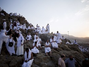 Muslim pilgrims gather to pray on and around the Jabal Al Rahma holy mountain, or the mountain of forgiveness, at Arafat for the annual hajj pilgrimage outside the holy city of Mecca, Saudi Arabia, Thursday, Aug. 31, 2017. (AP Photo/Khalil Hamra)