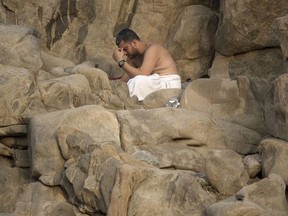 A pilgrim prays at the Jabal Al Rahma holy mountain, or the mountain of forgiveness, at Arafat for the annual Muslim hajj pilgrimage outside the holy city of Mecca, Saudi Arabia, Thursday, Aug. 31, 2017. (AP Photo/Khalil Hamra)