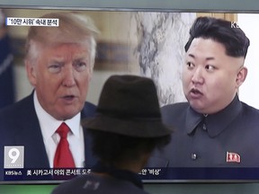 In this Aug. 10, 2017, file photo, a man watches a TV screen showing U.S. President Donald Trump, left, and North Korean leader Kim Jong Un during a news program at the Seoul Train Station in Seoul, South Korea.