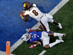 Central Michigan wide receiver Corey Willis (8) fans into the end zone over Kansas cornerback Derrick Neal (7) to score a touchdown during the first half of an NCAA college football game, Saturday, Sept. 9, 2017, in Lawrence, Kan. (AP Photo/Charlie Riedel)