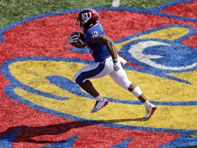 Kansas running back Khalil Herbert (10) runs the ball to score a touchdown during the first half of an NCAA college football game against the West Virginia, Saturday, Sept. 23, 2017, in Lawrence, Kan. (AP Photo/Charlie Riedel)