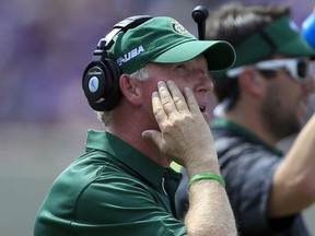 Charlotte head coach Brad Lambert looks at the scoreboard during the first half of an NCAA college football game against Kansas State in Manhattan, Kan., Saturday, Sept. 9, 2017. (AP Photo/Orlin Wagner)
