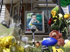 A memorial to three-year-old Evan Brewer sits in front of a home in Wichita, Kan., Wednesday, Sept. 6, 2017. A boy, whose body was found encased in concrete in a Wichita rental home, is believed to be the son of a woman named in an order seeking to protect him from abuse, police said Tuesday. Wichita police Lt. Jeff Gilmore told reporters that the body found Saturday in the rental home is likely that of Brewer, though authorities are awaiting DNA results for final confirmation. (Fernando Salazar/The Wichita Eagle via AP)