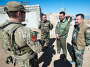 A Canadian special forces soldier, left, speaks with Kurdish Peshmerga fighters at an observation post in northern Iraq.