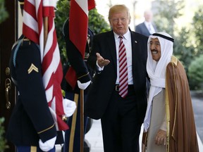 FILE- In this Thursday, Sept. 7, 2017 file photo, President Donald Trump, center, gestures as he greets the Amir of Kuwait Sheikh Sabah Al Ahmad Al Sabah as he arrives at the White House in Washington. Kuwait says it will expel North Korea's ambassador and four other diplomats from its embassy in Kuwait City. (AP Photo/Carolyn Kaster, File)